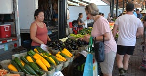 woman buying from vendor at farmers market