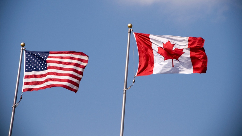 American and Canadian flag flying side by side