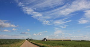 A beautiful summer day and a dramatic sky add a sense of beauty to this rural landscape in west-central Iowa, where the grave