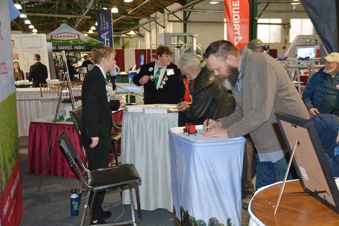 New York Farm Show visitors fill out a questionnaire