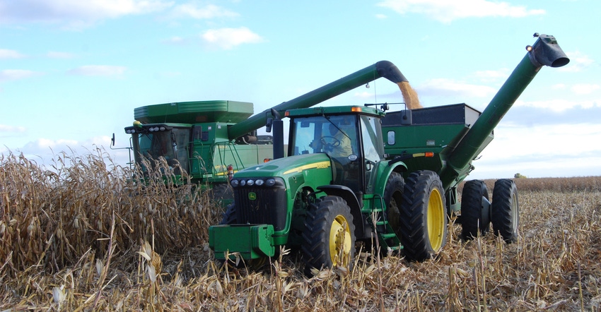 combine in corn field during harvest