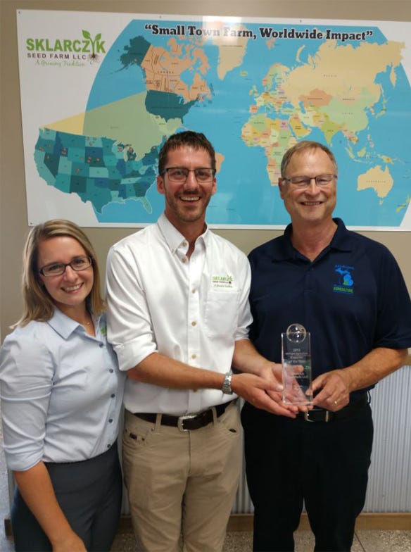 Sklarczyk Seed Farm is the 2019 Ag Exporter of the Year. Pictured are (from left) Alison Sklarczyk, Ben Sklarczyk and MDARD Director Gary McDowell. 