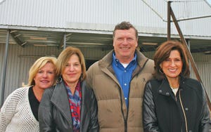 GREGG SAIN, SCGA Ginner of the Year, in front of the Hargrave Corner, Ark., ginâ€™s brand new seed house. From left are sisters-in-law Pam Bronson and Teresa Frankel, and Sainâ€™s wife, Ginger. (Click to enlarge photo)