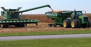 A combine unloads corn into an adjacent cart on this farm in Galena, Maryland