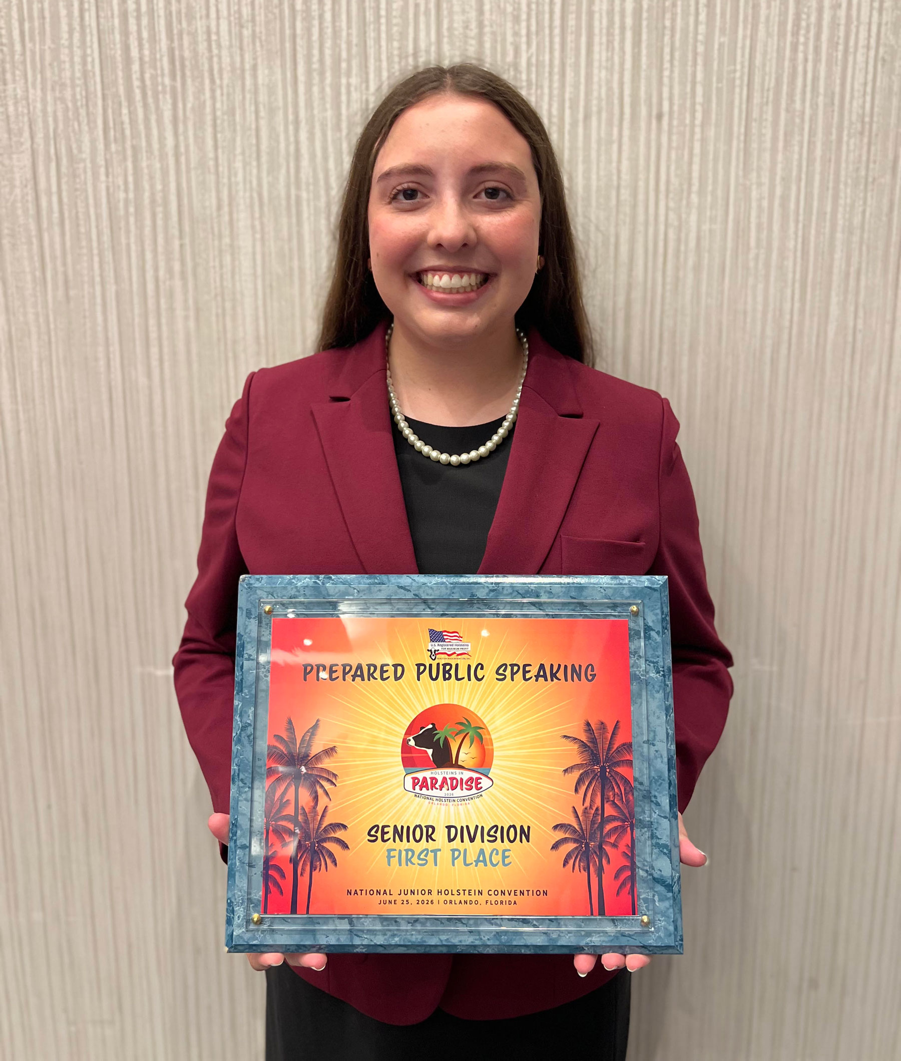 Sophie Geppert holds her plaque from the 2026 National Holstein Convention public speaking contest