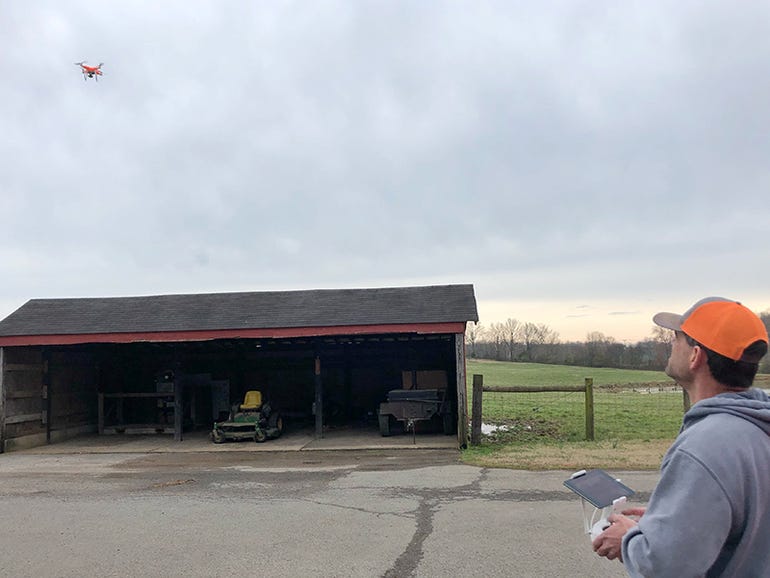 Farmer Corey Blick tries out a drone on a pasture system in Springfield, TN. 