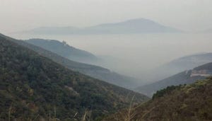 A smoky valley view from Priest Grade, looking down to the town of Moccasin, Calif.