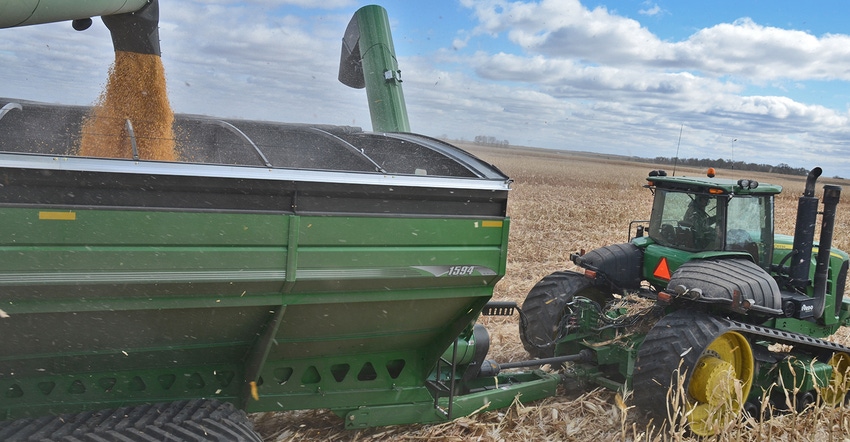 combine loads grain cart with corn
