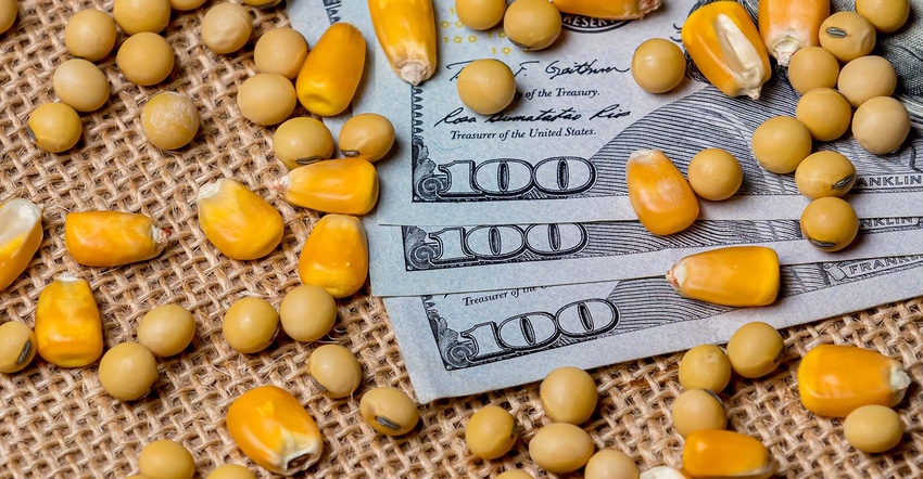 one hundred dollar bills with corn and soybeans