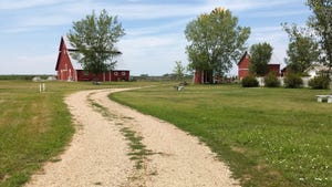 gravel drive leading to a barn