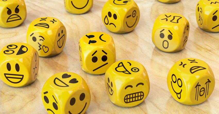 yellow dice with different emoticon faces on them