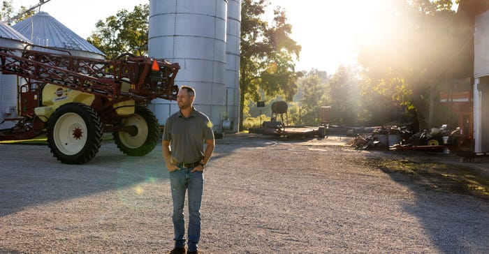 Joel Barickman looks out over the Barickman farm during a early, sunny morning