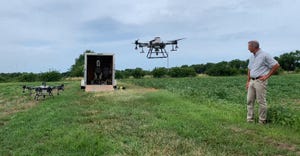 University of Missouri Extension weed scientist Kevin Bradley watches a drone lift of during the July 7 MU Pest Management Fi