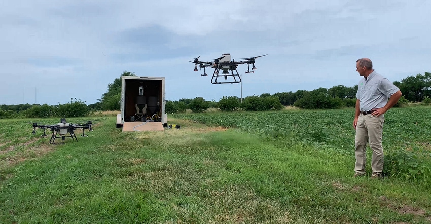 University of Missouri Extension weed scientist Kevin Bradley watches a drone lift of during the July 7 MU Pest Management Fi