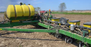 corn planter equipped with row cleaners and aftermarket closing wheels