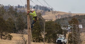 Worker working on telephone wires for broadband services