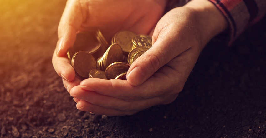 close-up of farmer holding coins in his hands