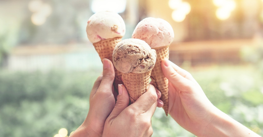 hands holding ice cream cones