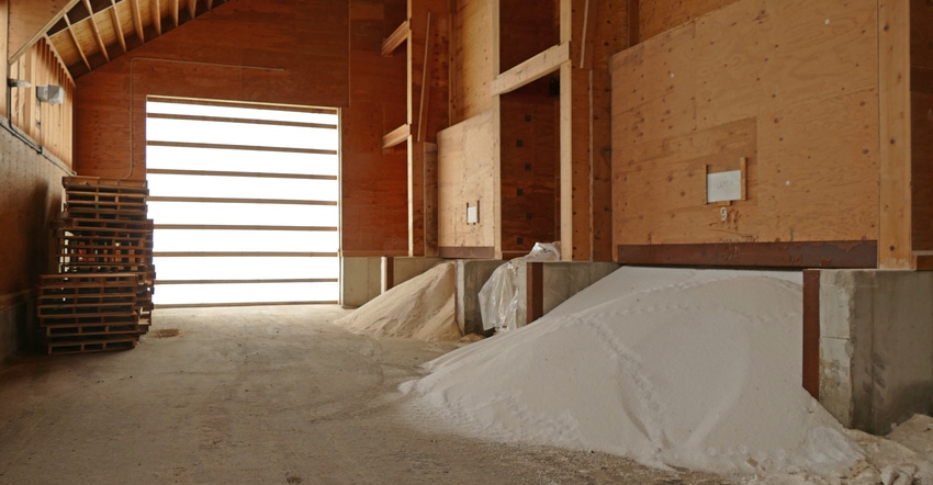 piles of fertilizer being stored in barn