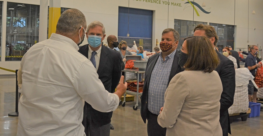 USDA secretary Tom Vilsack and Minnesota agriculture commissioner Thom Petersen tour Second Harvest Heartland