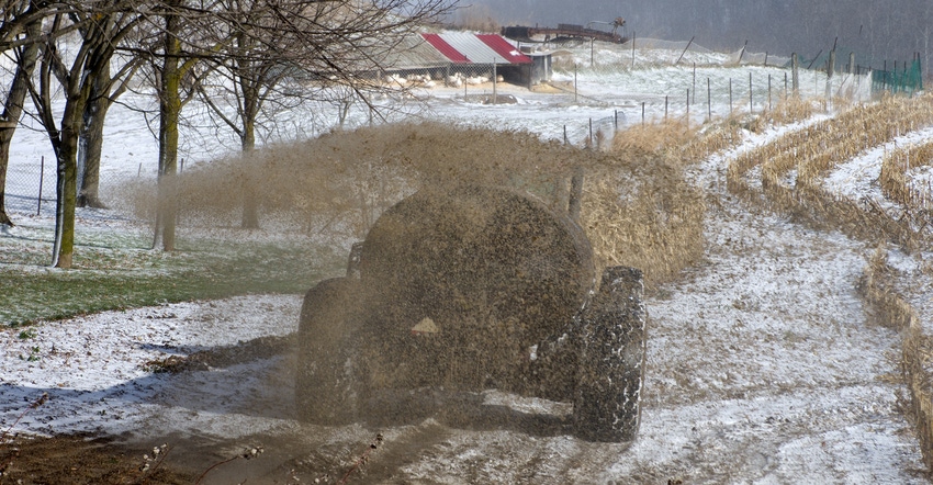 Manure is spread on a snow-covered field
