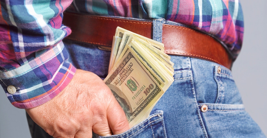 man putting money in pocket