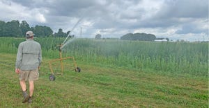 MSU Research Technician, Chris Robbins oversees an irrigation application to industrial hemp plots on the MSU South Campus Re