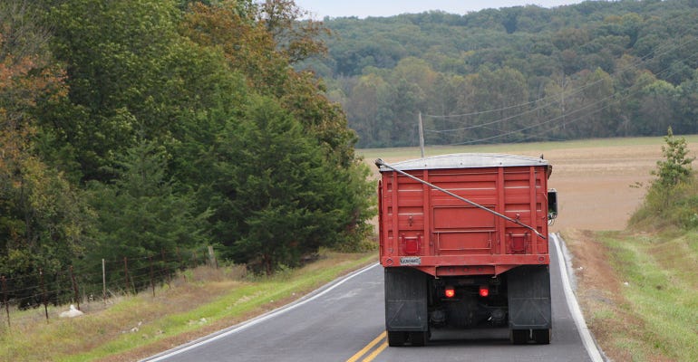 view of back end of a grain truck on the highway