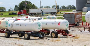 Anhydrous ammonia tanks near elevator grain trucks
