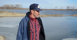 Scott Olson looks at flooding on his farm along the Missouri River near Tekamah
