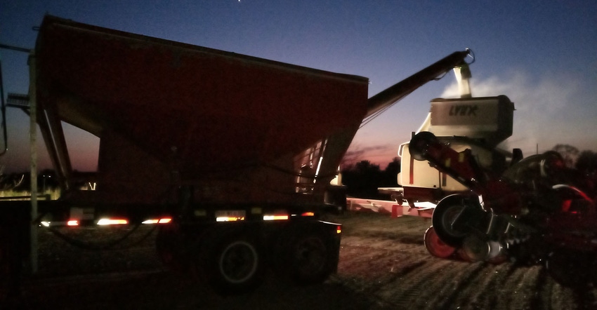 evening shot of feeder wagon putting seed into planter