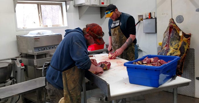 Rob Isaacson and Josh Holm workiing at Backroad Meats 