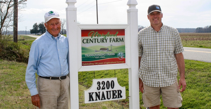Frank Knauer and his son Mike stand beside the sign for Transquaking Farm