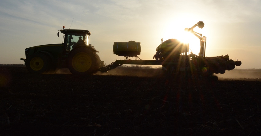 silhouette of tractor and planter 