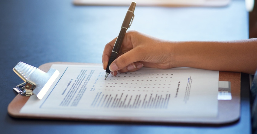 Cropped shot of a woman filling in a questionnaire Cropped shot of a woman filling in a questionnaire