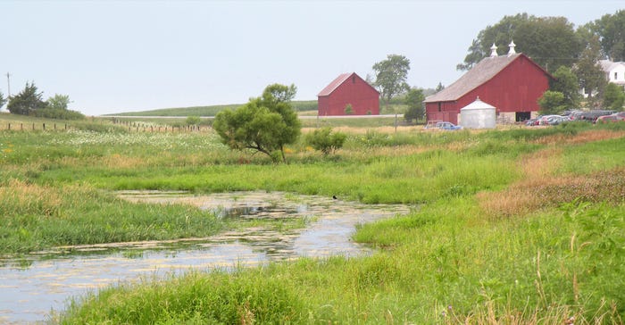creek and red barn and farmland