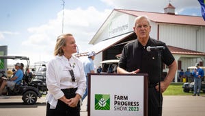 Rep. Nikki Budzinski standing next to Secretary Tom Vilsack at the Farm Progress Show.