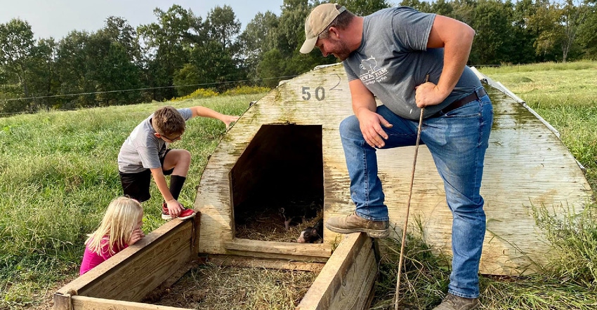 David Newman and his children check on baby pigs on the family farm in south central Missouri