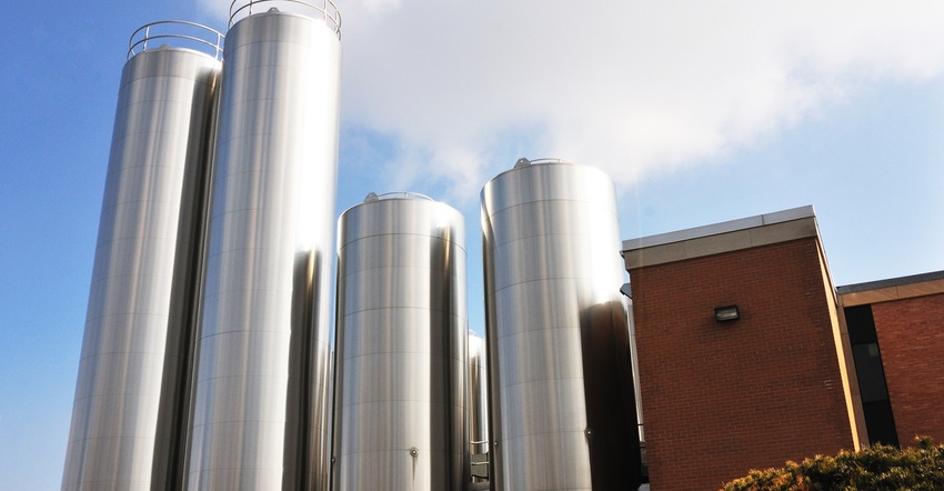 Stainless steel storage tanks and buildings at a dairy processing plant