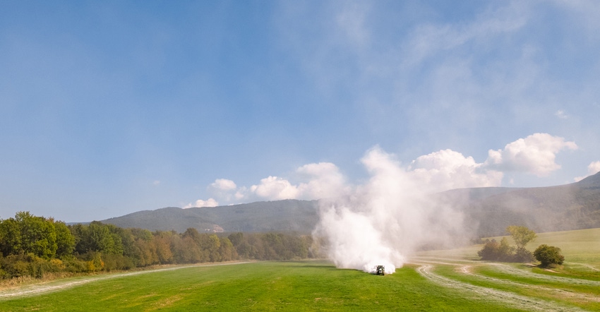 tractor spreading lime onto field