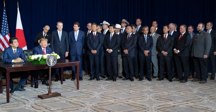 President Donald J. Trump is shown participating in a trade agreement signing ceremony with Japan Prime Minister Shinzo Abe i