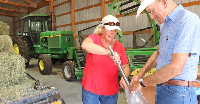 Eldon Cole helps sample Marcia Moreland's fifth cutting of alfalfa this year