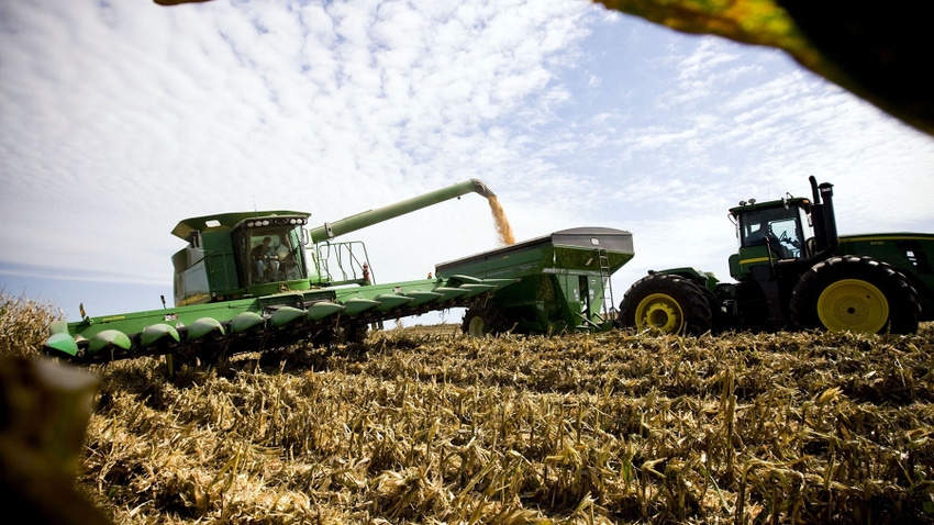 Combine unloading corn into grain cart during harvest