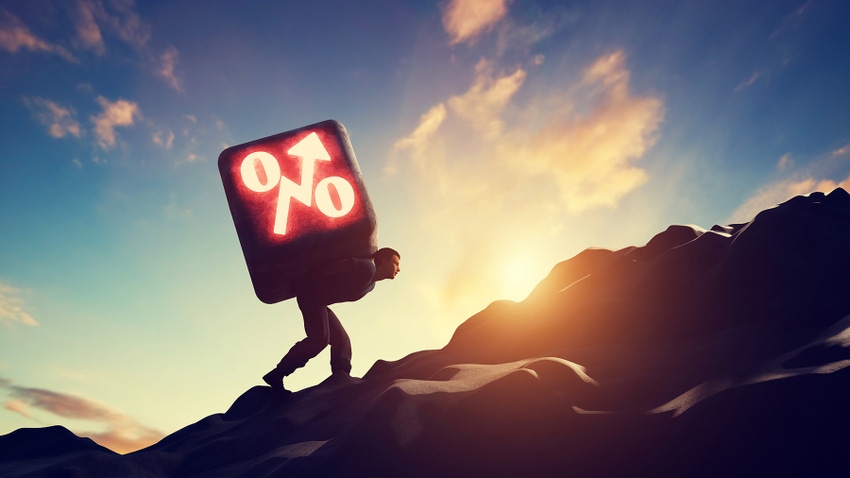Man carrying heavy stone with growing interest rate symbol increasing debt. Man carrying heavy stone with growing interest rate symbol increasing debt.