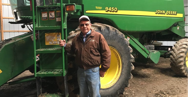 Jim Domagalski standign infront of johne deere 9450 tractor