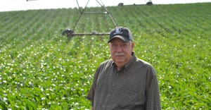 Rich Uhrenholdt standing in a field on his farm in Elgin Nebraska