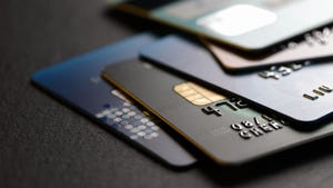  Stack of multicolored credit cards on black background