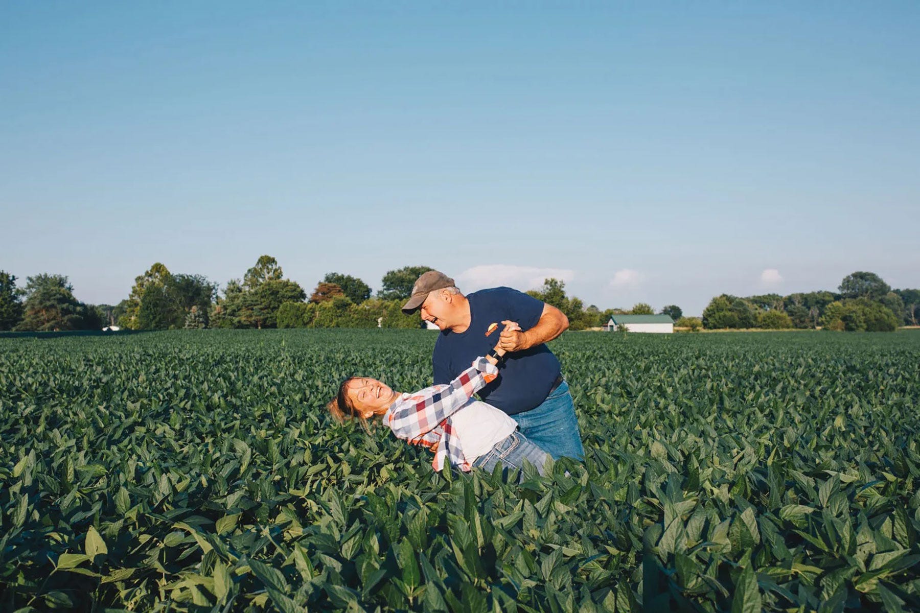 Chris and Jennifer Campbell dance in a field
