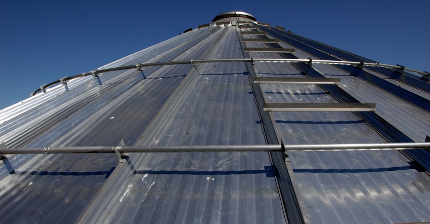 view from base of grain bin looking up towards blue sky