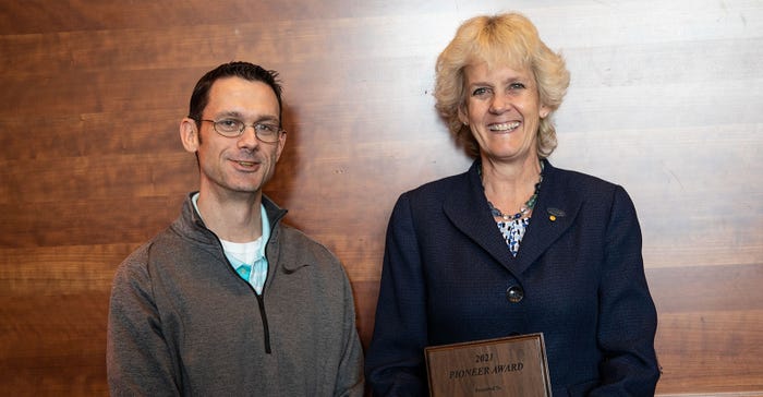 Alison Van Eenennaam, Davis, California, receives the Beef Improvement Federation Pioneer Award from her colleague Dr. Matt Spangler